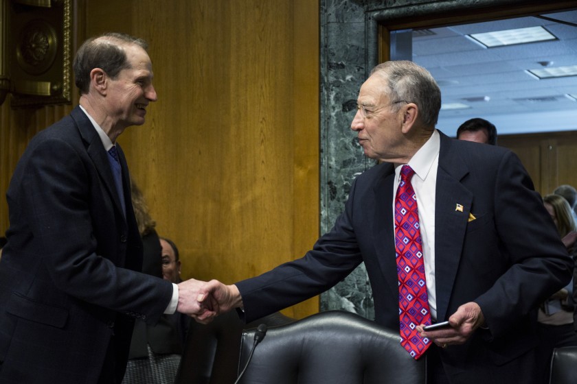 Senate Finance Committee ranking member Ron Wyden, D-Ore. (left), shakes hands with committee chairman Chuck Grassley, R-Iowa.
