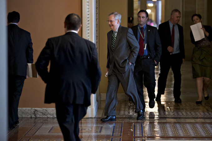 Senate Majority Leader Mitch McConnell, a Republican from Kentucky, center, walks to a private GOP meeting at the U.S. Capitol in Washington, D.C.,  on the day of the unveiling of the GOP health care bill