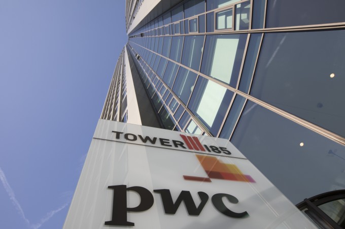 The PricewaterhouseCoopers LLP logo sits on a sign outside 51-storey skyscraper Tower 185 in Frankfurt, Germany.