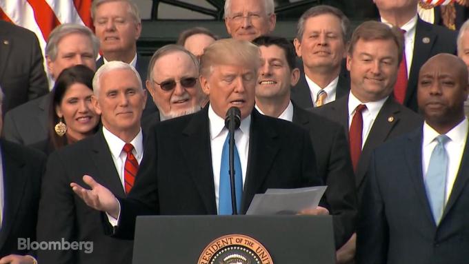 President Donald Trump speaks after passage of the tax cut legislation alongside Vice President Mike Pence and Sen. Tim Scott, R-S.C., with House Speaker Paul Ryan, R-Wis., and other Republican lawmakers behind him.