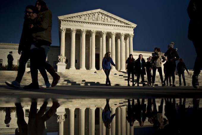 Visitors walk in front of the U.S. Supreme Court building in Washington, D.C.