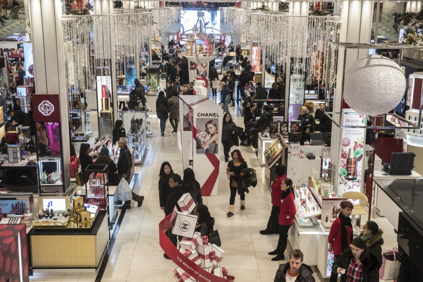 Shoppers walk through a Macy's department store in New York