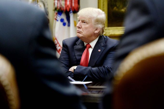 President Donald Trump listens during a meeting with the National Association of Manufacturers in the White House