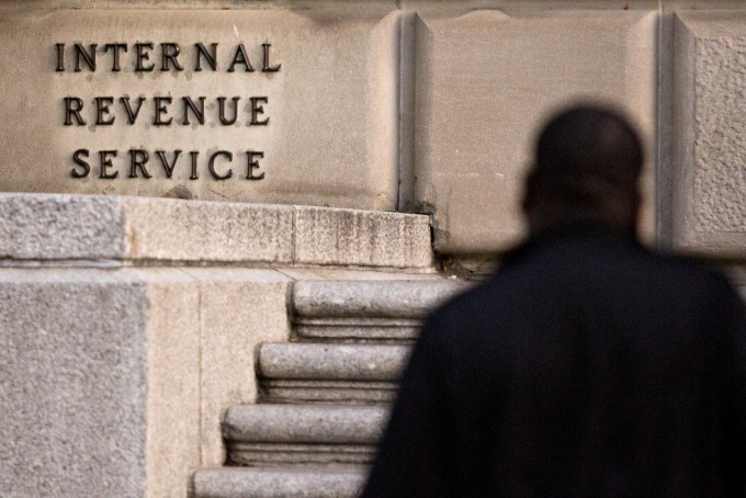 A man walks past the IRS headquarters in Washington, D.C.