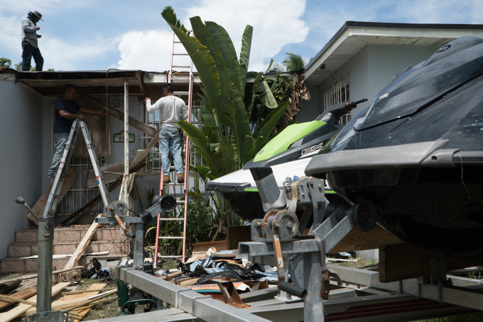 Contractors prepare a home ahead of Hurricane Irma in Miami, Florida.