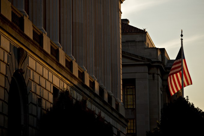 An American flag flies outside the Internal Revenue Service headquarters at sunrise in Washington, D.C.