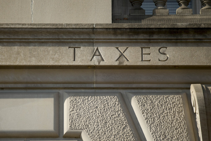 The word taxes is engraved on the side of IRS headquarters in Washington, D.C.