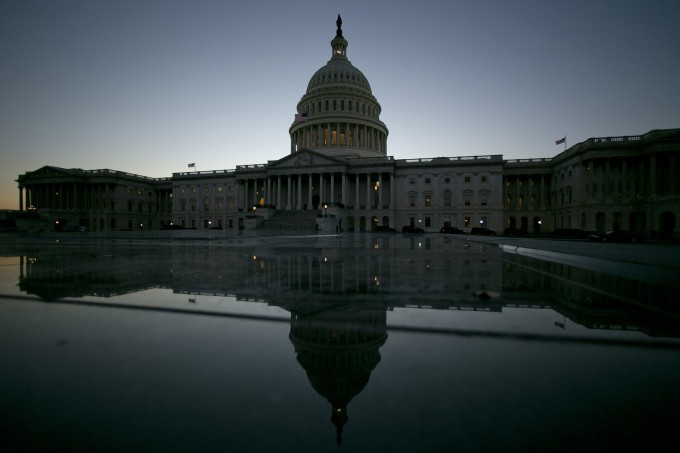 The U.S. Capitol building is reflected in Washington, D.C.